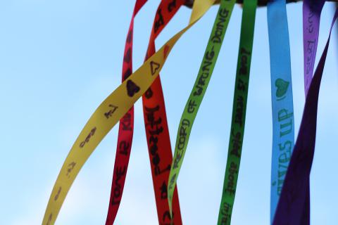 photo of 1 Corinthians 13 verses written on rainbow ribbons